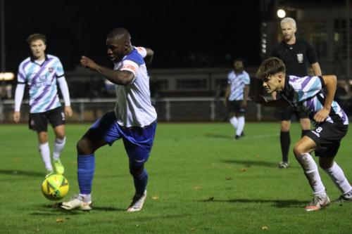 Enfield's Percy Kiangebeni (L) spins away from Archie Burnett