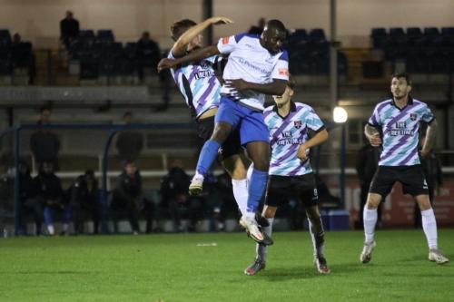 Enfield's Percy Kiangebeni (white shirt) challenges Ben Swift
