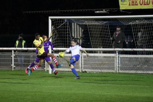 Enfield's Lee Chappell clears from Gus Sow