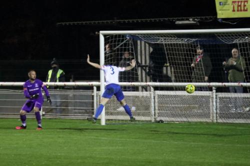 Enfield's Nathan McDonald (L) and Lee Chappell watch the ball flash across the goal
