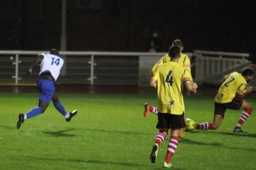 Enfield's Percy Kiangebeni sees his shot blocked by Harry Osborne (R)