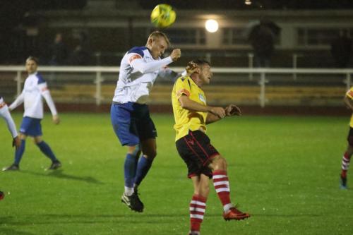 Enfield's Ryan Blackman (L) wins a header against Kenny Beaney