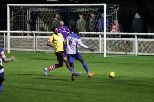 Kingstonian's Corie Andres (yellow) and Enfield's Adam Pepera (6) and Nathan McDonald