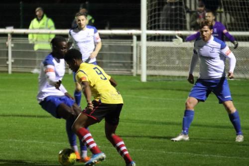 Kingstonian's Corie Andrews (yellow) runs at Adam Pepera