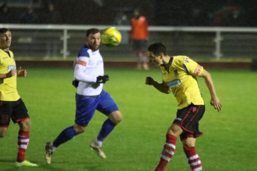 Kingstonian's Fabio Saraiva heads clear from Billy Bricknell