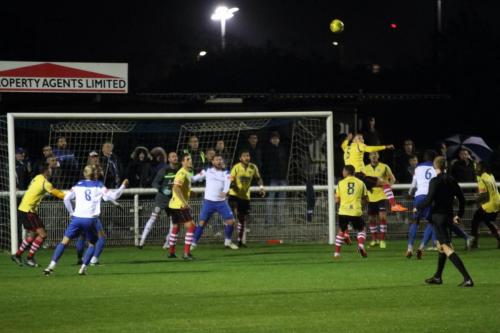 Kingstonian's Ollie Cook (5) heads clear