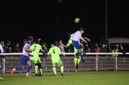 Enfield's Sam Youngs (R) wins a header