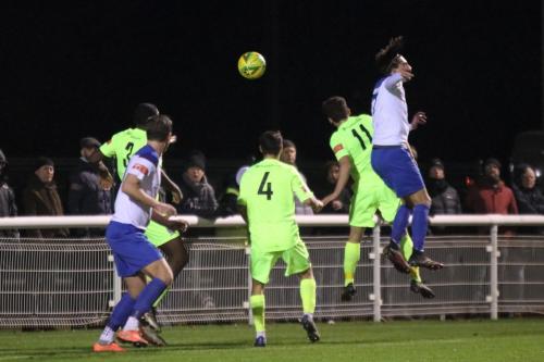 Enfield's Sam Youngs (R) wins a header