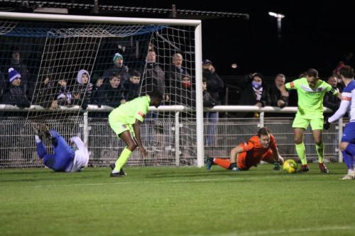 Maldon captain Martyn Stokes (green, R) clears after Ben McNamara's initial save