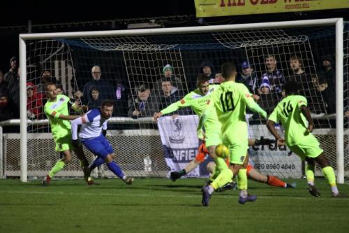 Maldon's Joseph Turpin (green, centre) clears