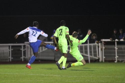 Enfield's Neville Nzembela (12) challenged by Joseph Turpin in the dying seconds of stoppage time