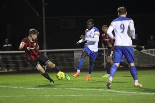 Brightlingsea's Adam Topley (L) clears