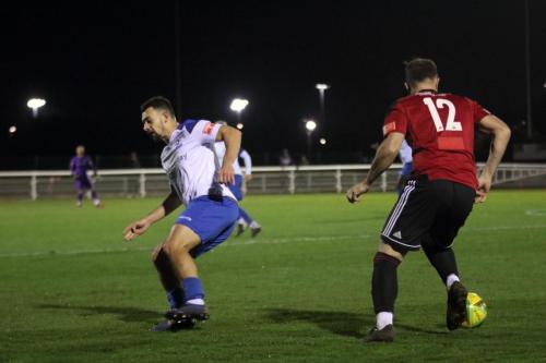 Brightlingsea's Joe Heron (R) sends Lyle Della-Verde the wrong way