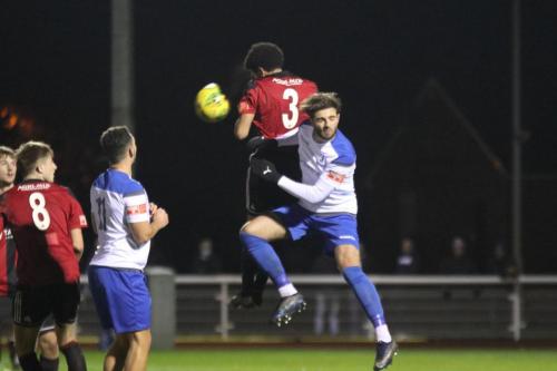 Enfield's Josh Urquhart (R) challenges Cadell Fraser-Robinson