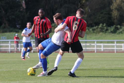 Enfield's Billy Bricknell (white) tussles with Nic D'Arienzo