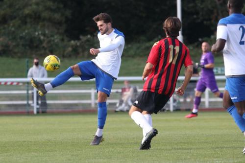 Enfield's Josh Urquhart (L) clears from Ronnie Conlon