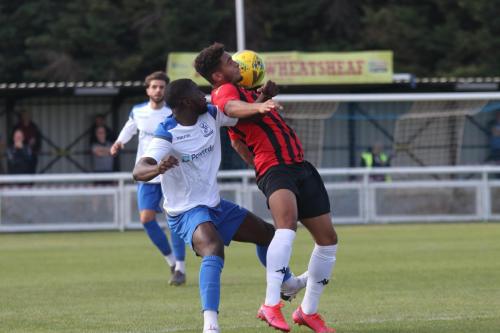 Enfield's Percy Kiangebeni (L) challenges Aaron Cosgrave