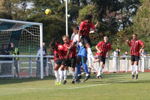 Enfield's Shaun Okojie (white shirt) heads narorowly over the bar