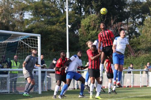 Lewes' Jaden Owusu-Nepaul (stripes, R) challenges Sam Youngs  (R)