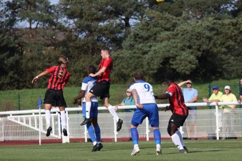 Lewes defender Fintan Walsh (L) gets his head to a long throw but his header loops into his own net to put Enfield 2-0 ahead
