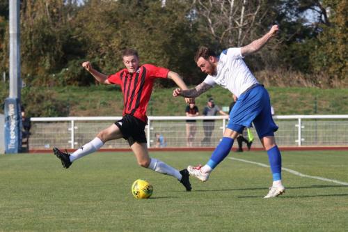 Nic D'Arienzo (L) tries to block a shot from Enfield's Billy Bricknell