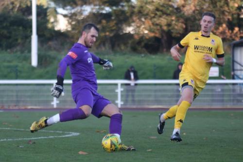 Enfield's Dan Lincoln clears from Luke Carey