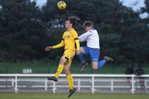 Enfield's Lee Chappell (R) heads clear from George Nikaj