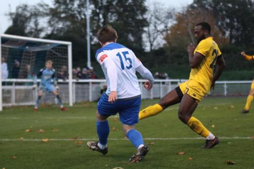 Enfield's Lewis Taaffe (L) crosses as Jerald Aboagye tries to block