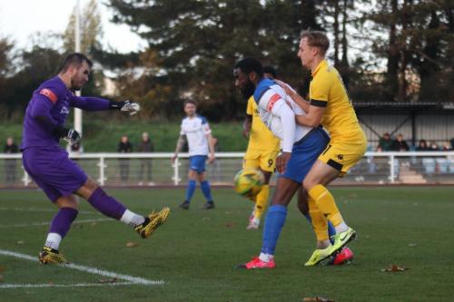 Enfield keeper Dan Lincoln clears as Harold Joseph holds off Ramsgate's Theo White (R)