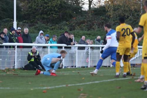 Ramsgate keeper Jacob Russell saves as Billy Bricknell (white) looks for a possible rebound