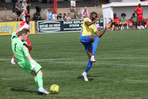 Carshalton keeper Tyler McCarthy clears from Muhammadu Faal