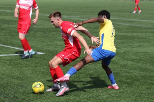 Carshalton's Bobby Price (L) and Enfield's Andre Coker