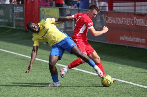 Enfield's Percy Kiangebeni (L) challenges Bobby Price