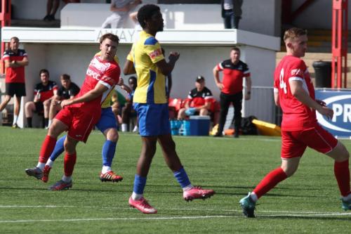 Lewis Taaffe (hidden by the Carshalton defender on the left) puts Enfield 3-2 ahead