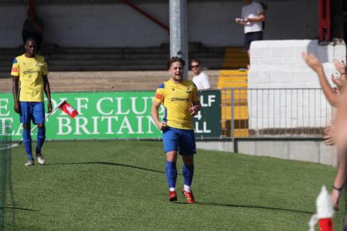 Enfield's Lewis Taaffe celebrates his goal with the travelling fans