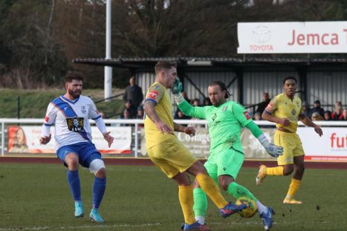 IMG 2515-Stortfords-Ryan-Henshaw-and-keeper-Jack-Giddens-both-try-to-clear-the-same-ball