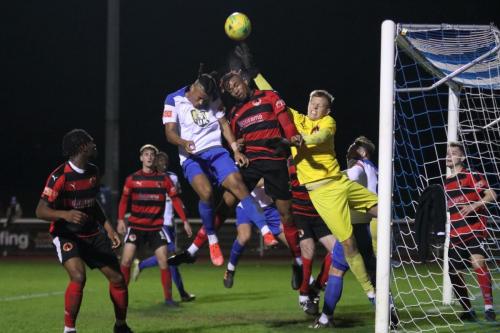 IMG 7193-Bedfont-keeper-George-Gay-punches-clear-under-pressure-from-teammate-Jonathan-Tadafe-and-Enfields-Luke-Cook