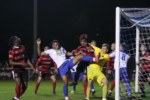 IMG 7195-Bedfont-keeper-George-Gay-punches-clear-under-pressure-from-teammate-Jonathan-Tadafe-and-Enfields-Luke-Cook