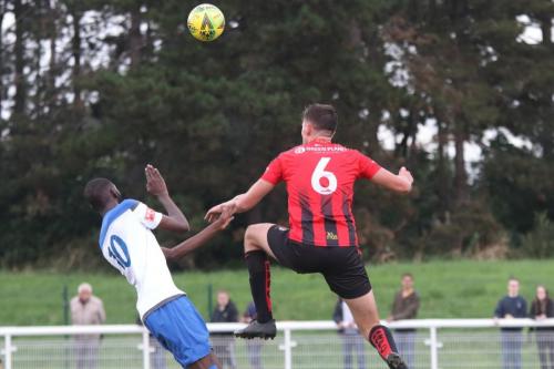 Regent's Jake Thompson (R) heads clear from Muhammadu Faal