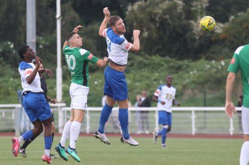 Enfield's Adam Cunnington (white, R) heads on goal