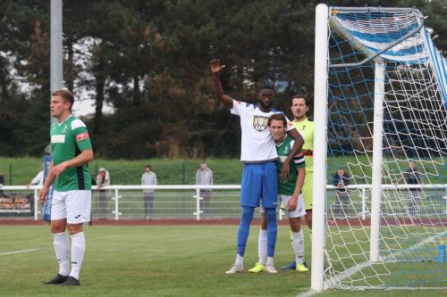 Enfield's Muhammadu Faal (white shirt) and Dereham's David Linton get acquainted