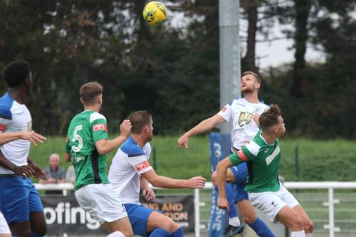 Enfield's Rian Bray (white, R) heads across goal