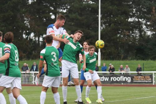 Enfield's Adam Cunnington (white) wins a header