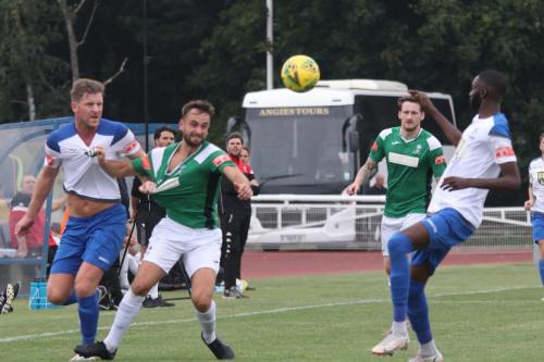 Enfield's Adam Cunnington (L) gets to grips with Robbie Linford