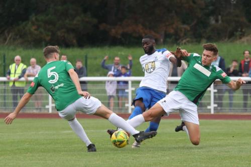 Enfield's Muhammadu Fall shoots under pressure from Matthew Castellan (L) and Ashton Fox
