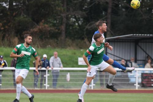 Enfield's Adam Cunnington (white) challenges Matthew Castellan