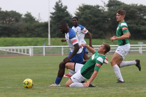 Dereham's Dion Frary challenges Percy Kiangebeni
