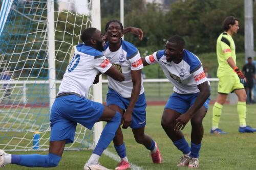 Muhammadu Faal (L), Andre Coker and Percy Kiangebeni (R) celebrate Coker's second goal