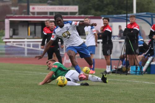 Enfield's Andre Coker evades a tackle from Dion Frary