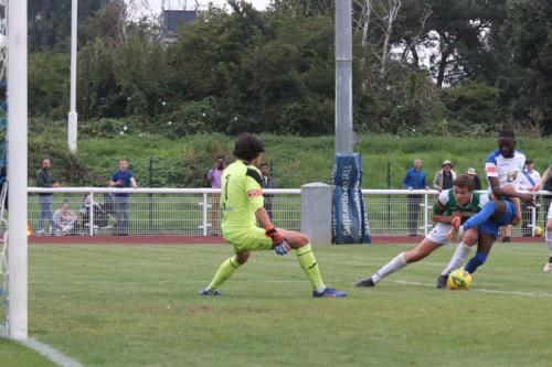 Enfield's Muhammadu Faal plays an air shot under pressure from a Dereham defender